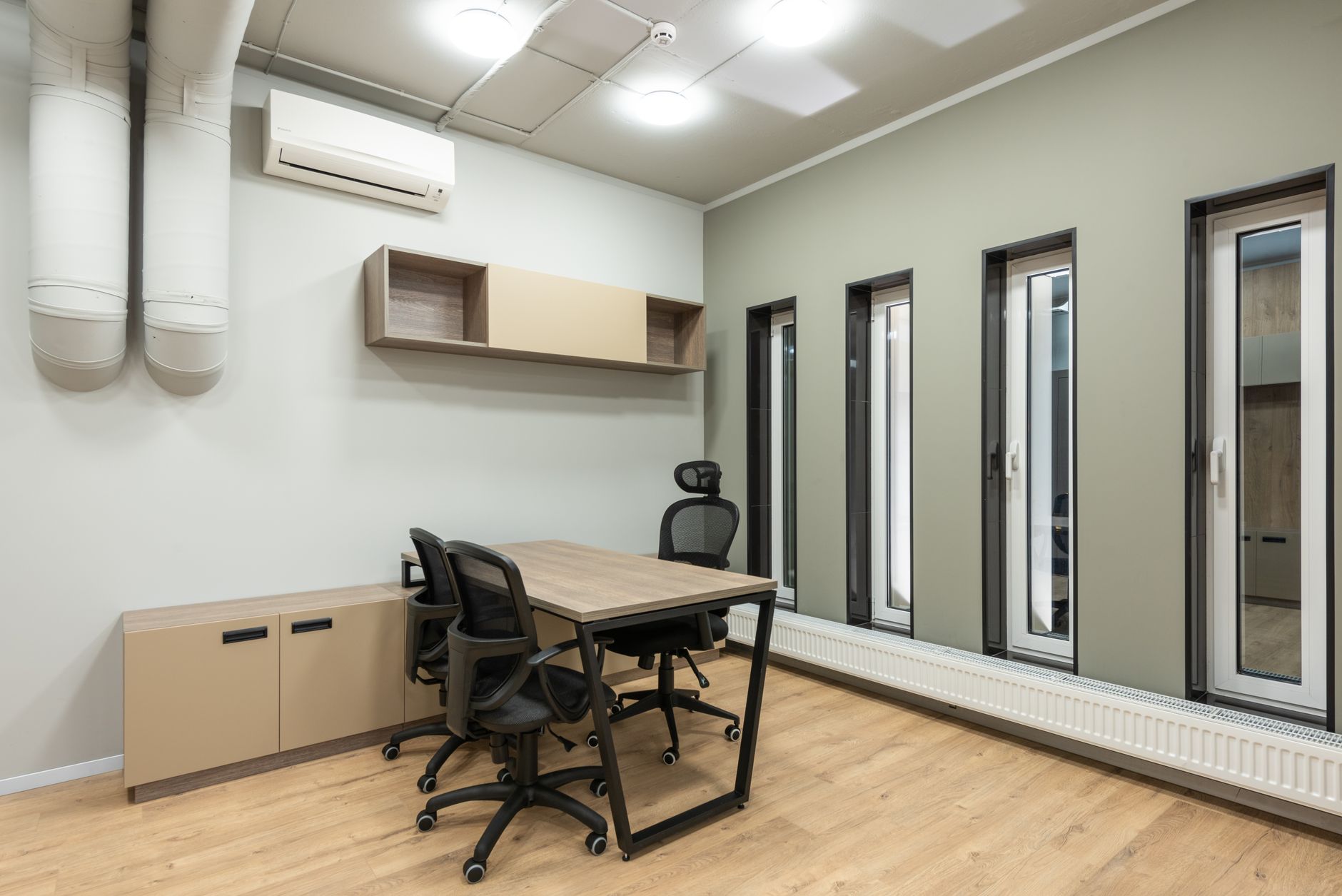 Spacious and contemporary office space featuring minimalist design and ample natural light.