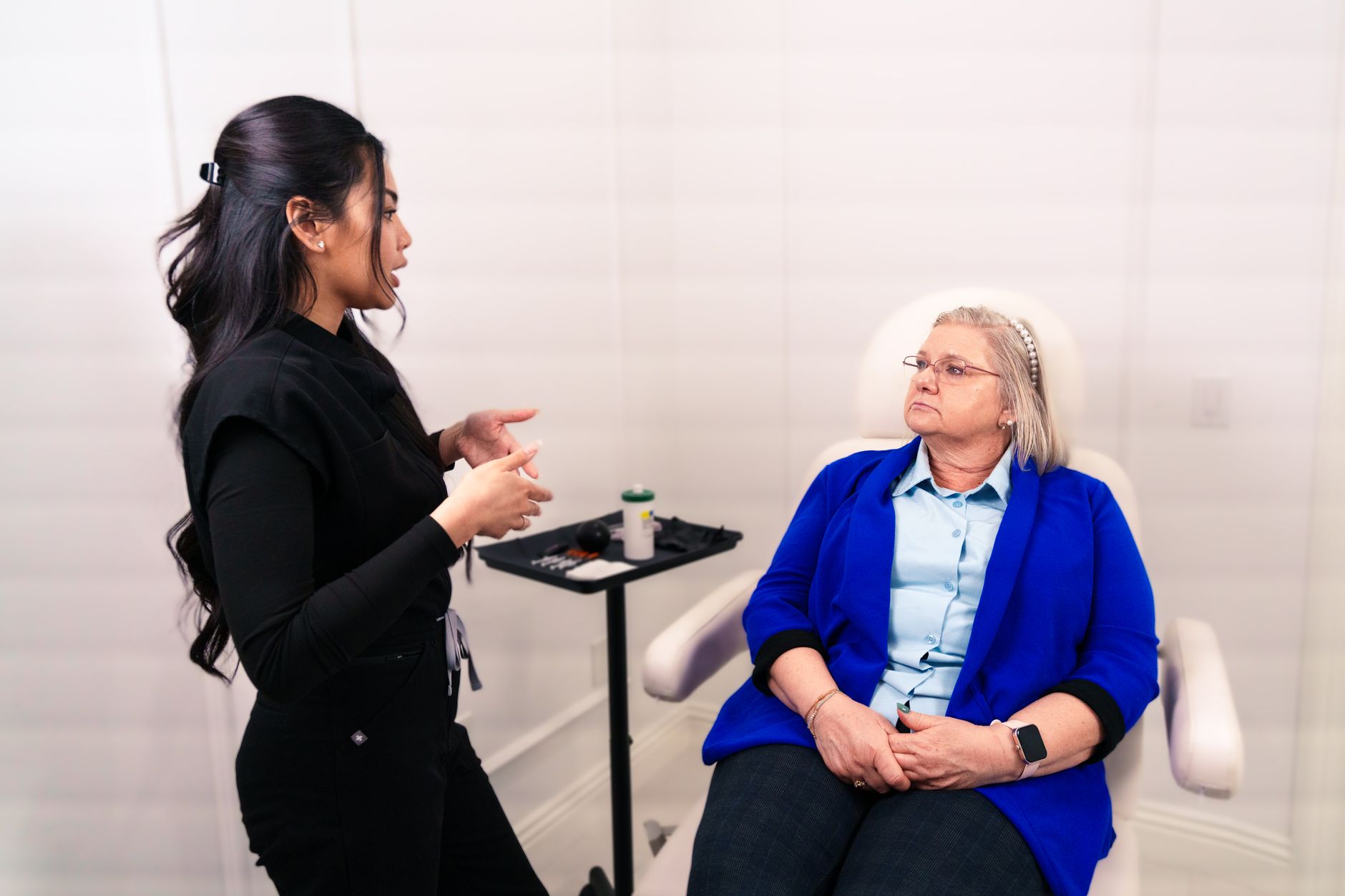 Female professional consulting with senior client in a Santa Ana med spa.